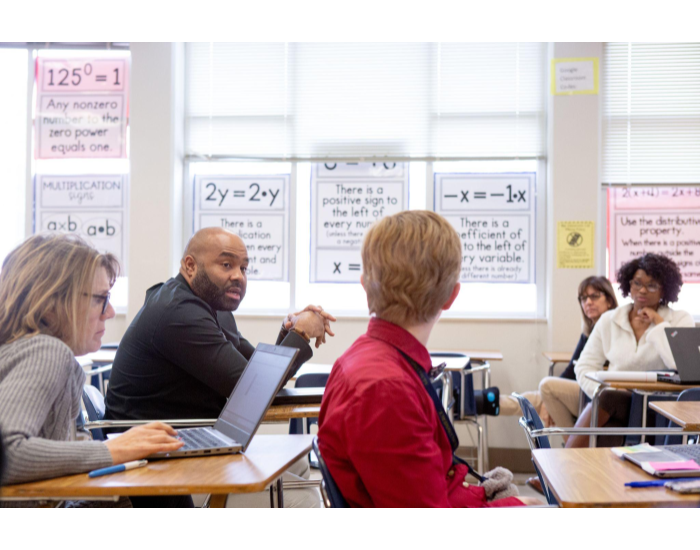 Sixth-grade math teachers discuss their lessons during a team planning session.